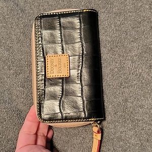 Dooney& Bourke small black wallet with two side pockets on inside. NWOT